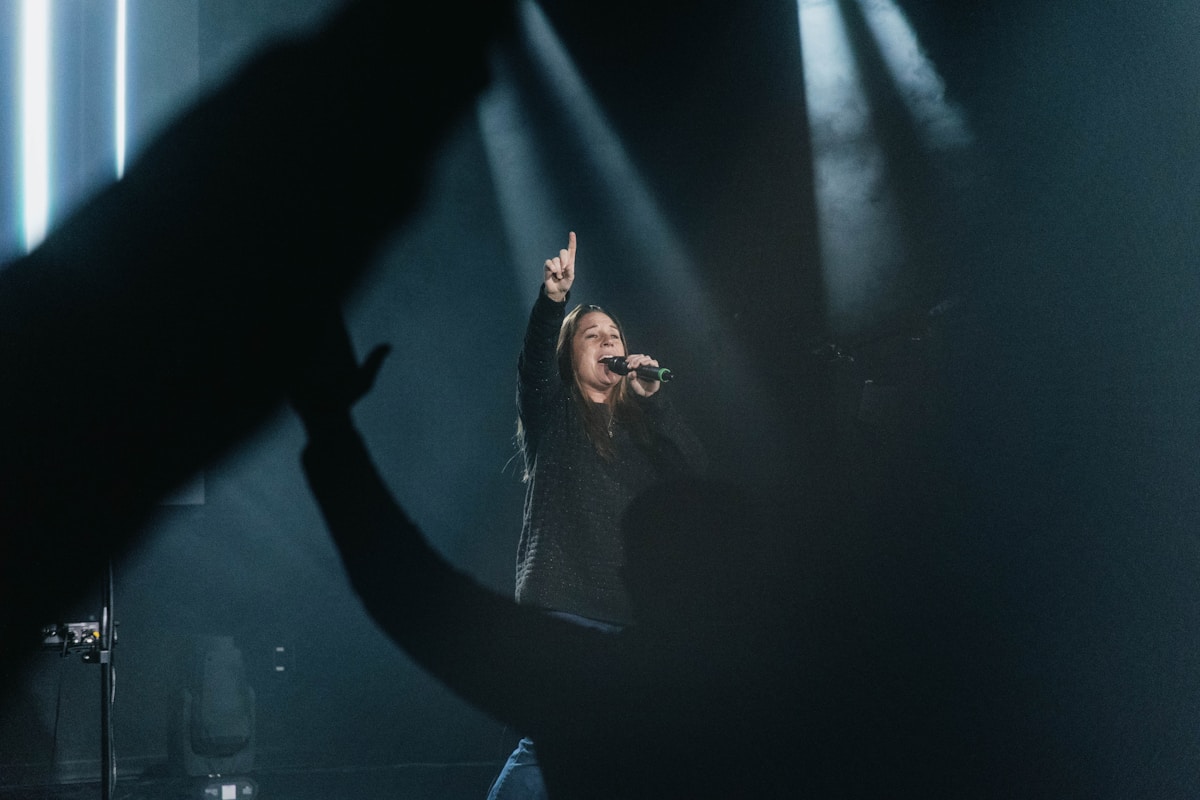 Worship leader singing on stage
